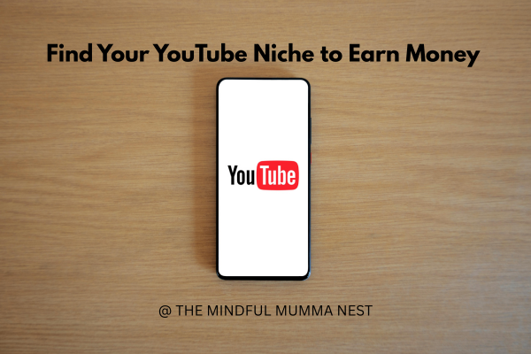 Mobile phone with YouTube logo on wooden table with text Find Your YouTube Niche to Earn Money – The Mindful Mumma Nest"
