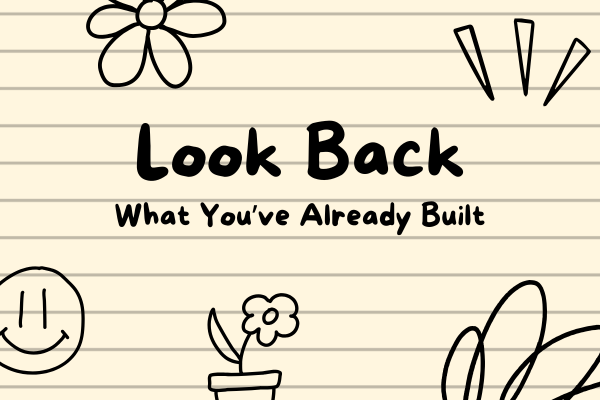 Look Back – Reflect on Your Housewife Job Journey So Far Notebook-style image with doodles and bold text saying “Look Back – What You’ve Already Built,” symbolizing reflection on progress in a housewife's online job journey