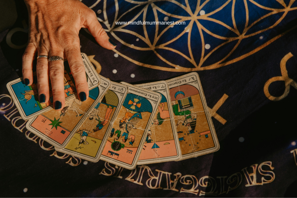 Hand reading tarot cards showing astrology to get job and earn money from home guidance
